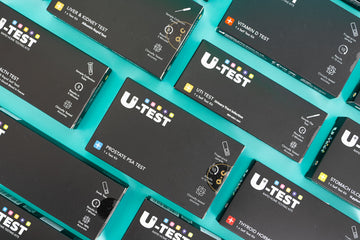 U-Test home test kit range arranged on a turquoise background