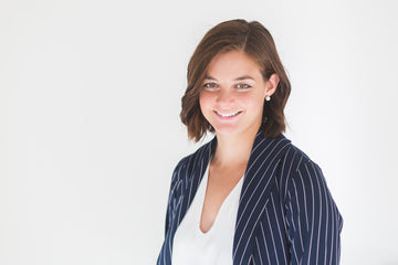 Portrait of a smiling woman in a striped blazer